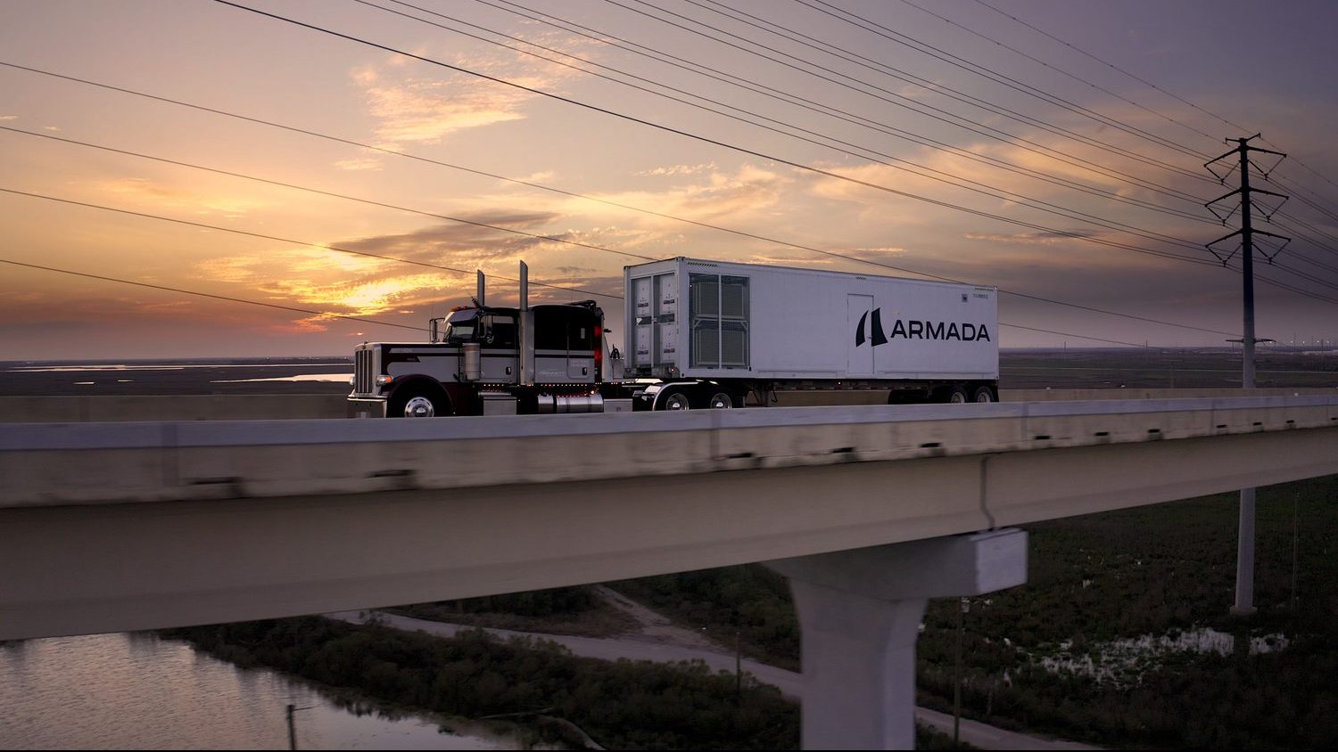 An Armada modular data center traveling by truck at sunset