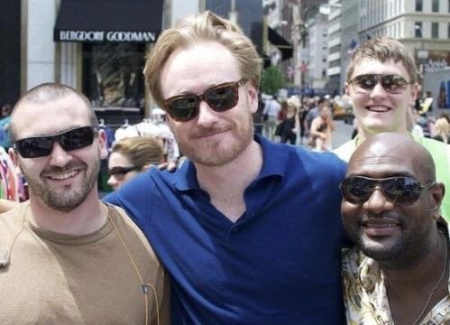 Conan O'Brien posing with three people from the line outside Bergdorf Goodman