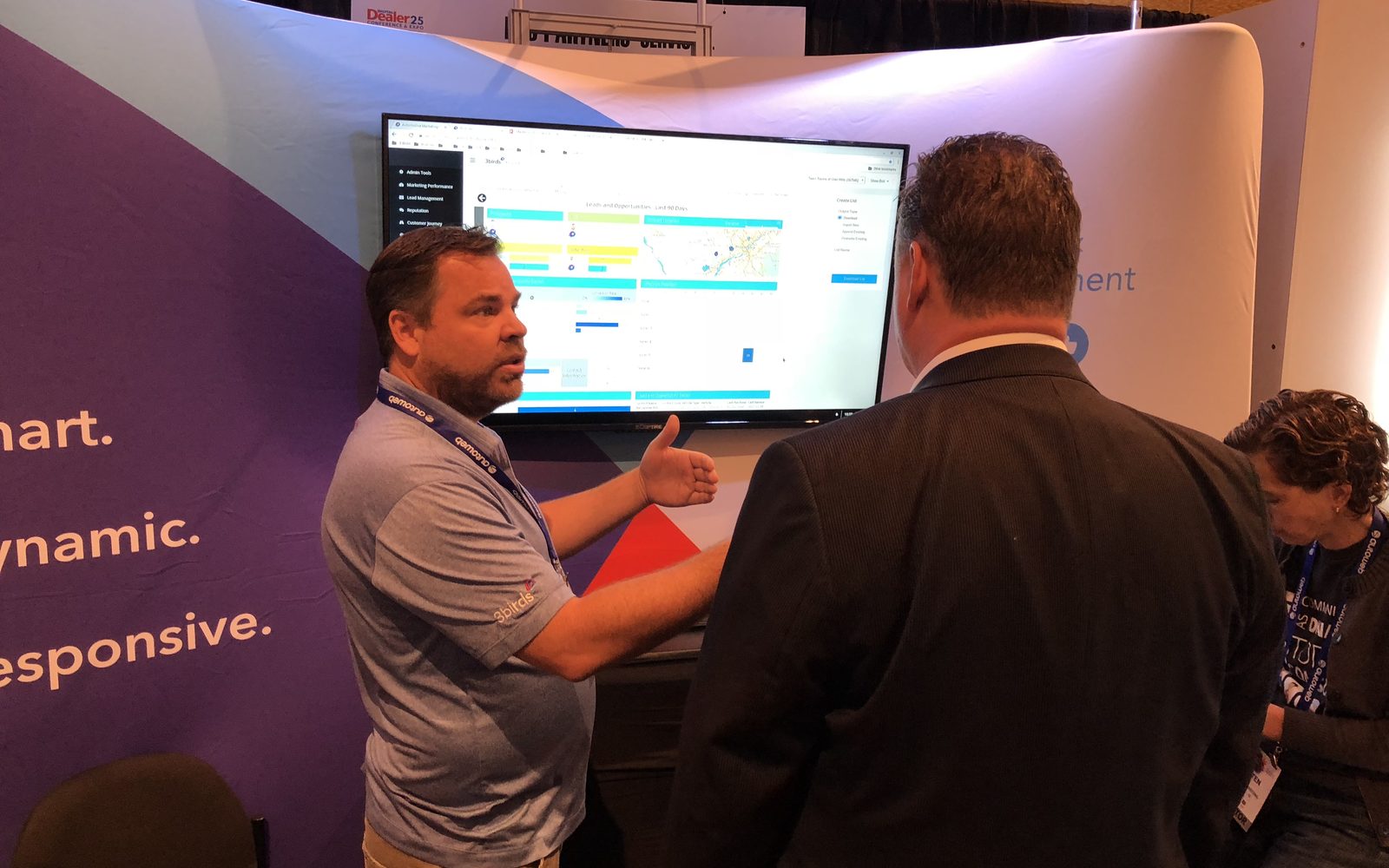 A 3 Birds Marketing product dashboard being demonstrated to a customer at the Digital Dealer conference