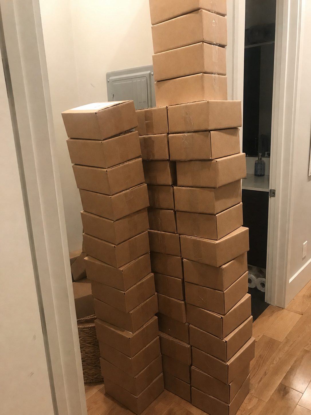 Stacks of packed WFH Care Packages filling the hallway of Taylor and Lauren's San Francisco apartment
